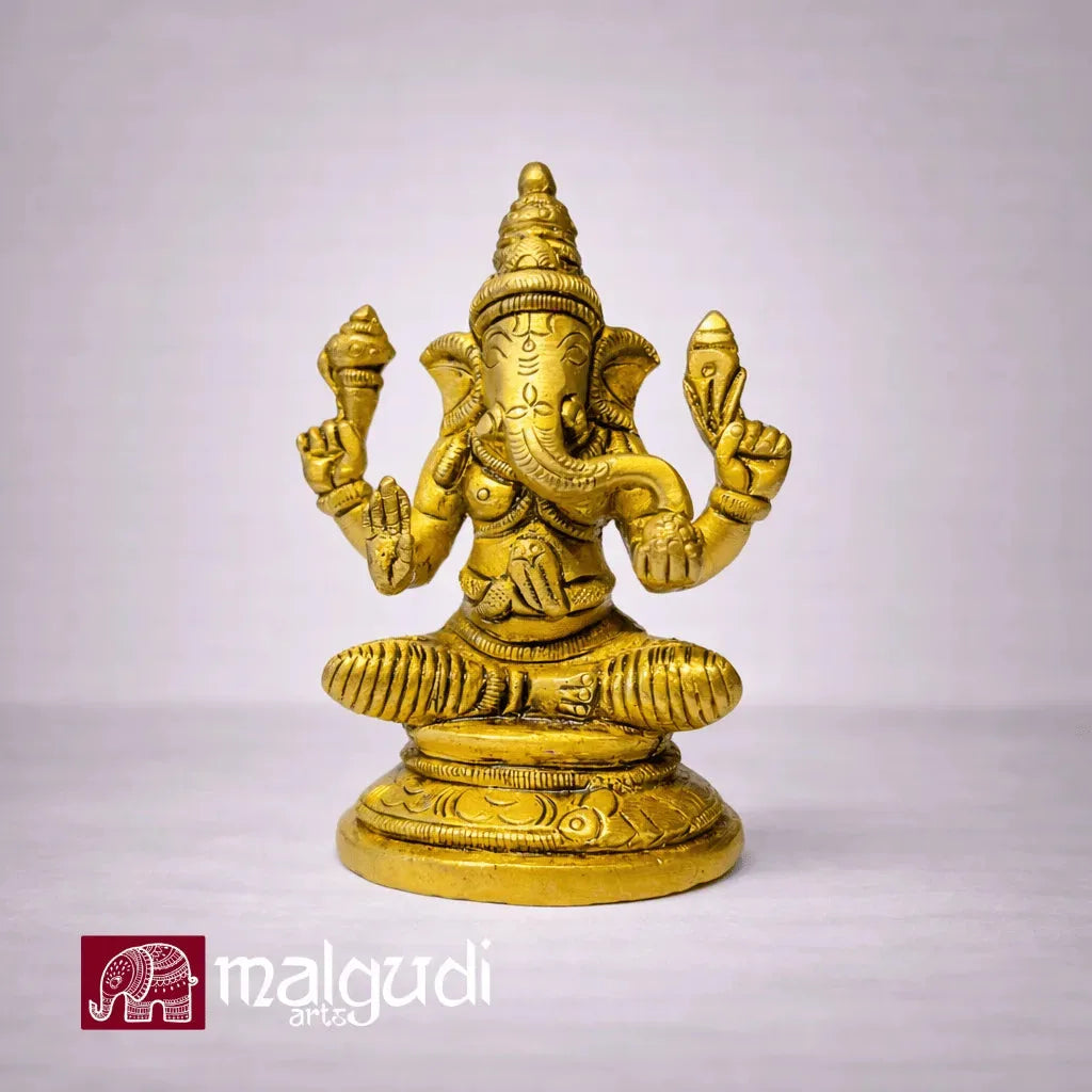 Brass Ganesha statue in lotus pose